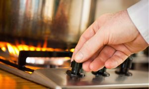 hand turning up burner