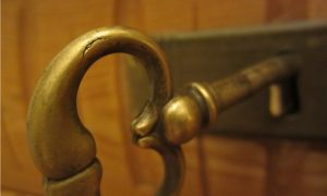 old fashioned key in keyhole