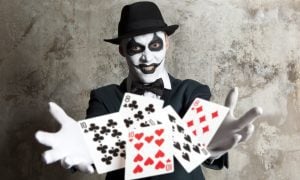 scary clown with playing cards