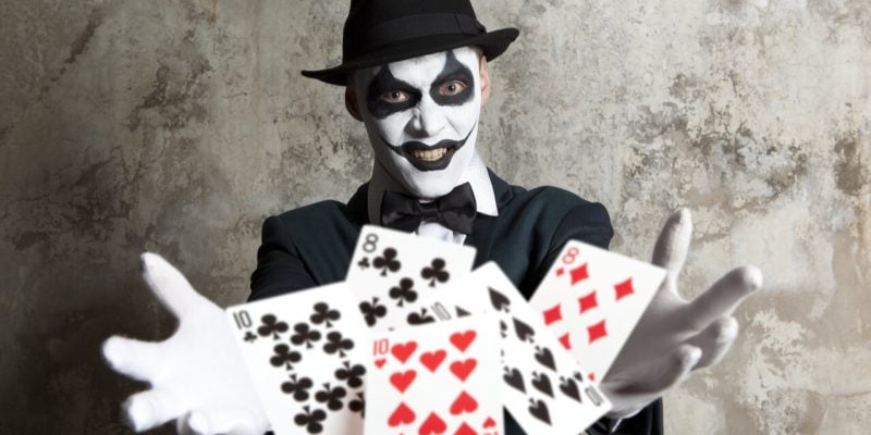 scary clown with playing cards