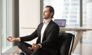 man in suit doing yoga