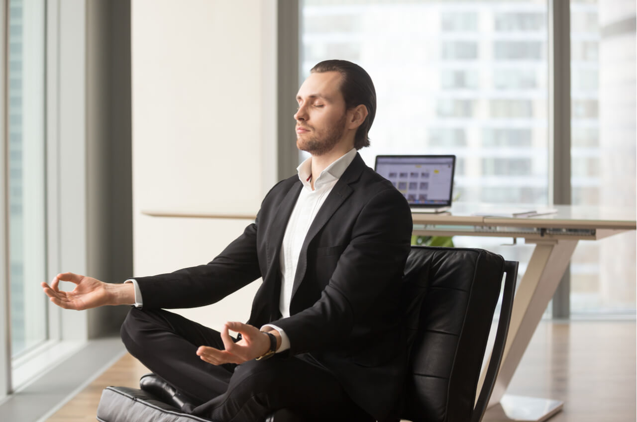 man in suit doing yoga