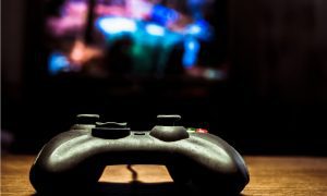 video game controller with game in the background