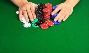 hands shoving poker chips all-in