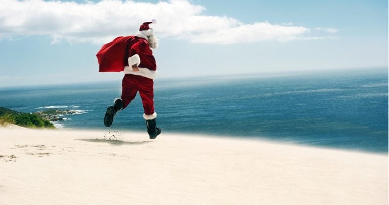 Santa Claus running on a sunny beach