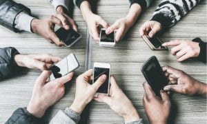 overhead view of hands using cell phones