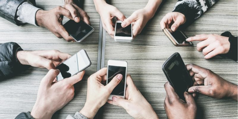overhead view of hands using cell phones