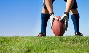 player setting football down for kickoff