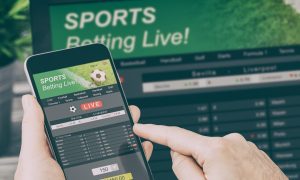 An image of someone playing sorts betting live on their phone