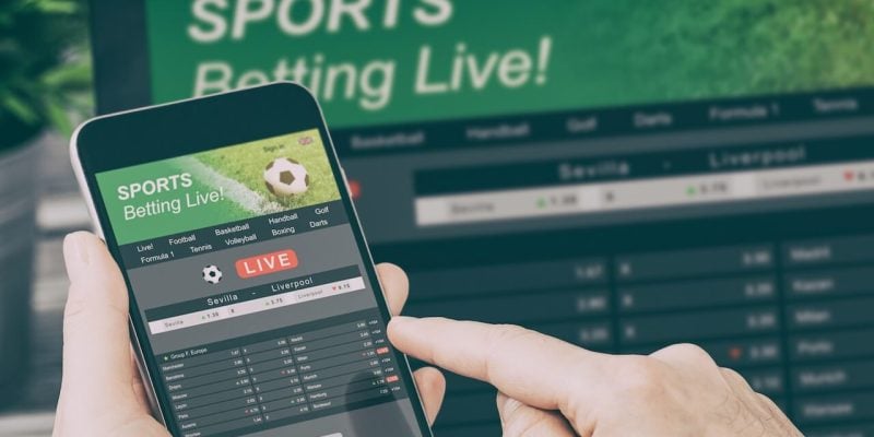 An image of someone playing sorts betting live on their phone