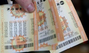 Someone holding six power ball tickets