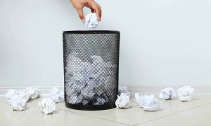 Trash can full of papers