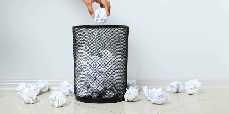 Trash can full of papers