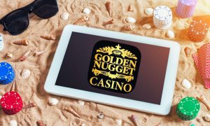 Tablet on a Sandy Beach with poker chips and Golden Nugget casino logo