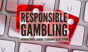 Two Red Dice On A Keyboard represent online gambling with responsible gambling