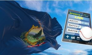 vermont flag flies against a blue sky next to a tablet operating an online sportsbook