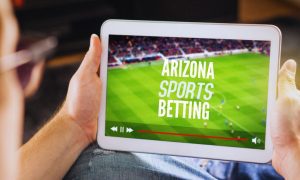 Man Watches Sporting Event on Tablet with Arizona sports betting