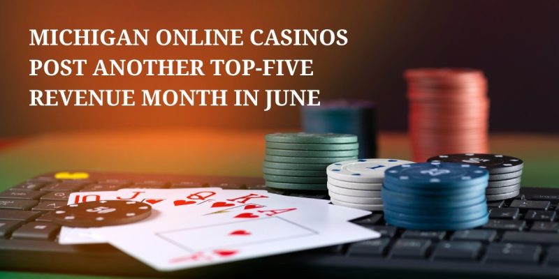 playing cards and gambling chips resting on keyboard representing michigan online casino revenue