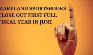 finger of wooden hand model pointing up signifying the first full fiscal year for maryland sports betting