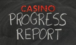 Blackboard with White Chalk Writing 'Progress Report' and New York Casino