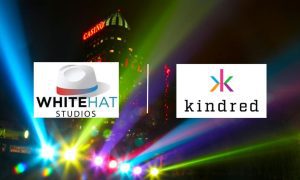 Casino Building and Lights at Night with White Hat Studios and Kindred Group logos