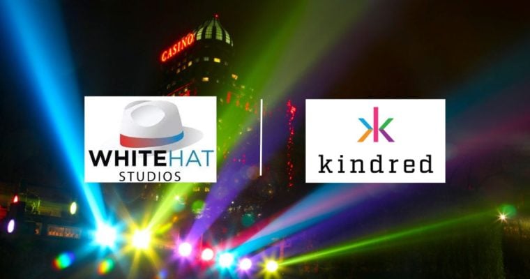 Casino Building and Lights at Night with White Hat Studios and Kindred Group logos