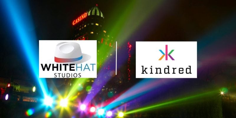 Casino Building and Lights at Night with White Hat Studios and Kindred Group logos