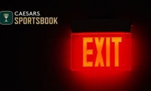Exit Sign Glows Red in the Dark with Caesars Sportsbook logo