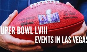 Gov. Joe Lombardo holds an NFL football with the Super Bowl LVIII logo and Events in Las Vegas