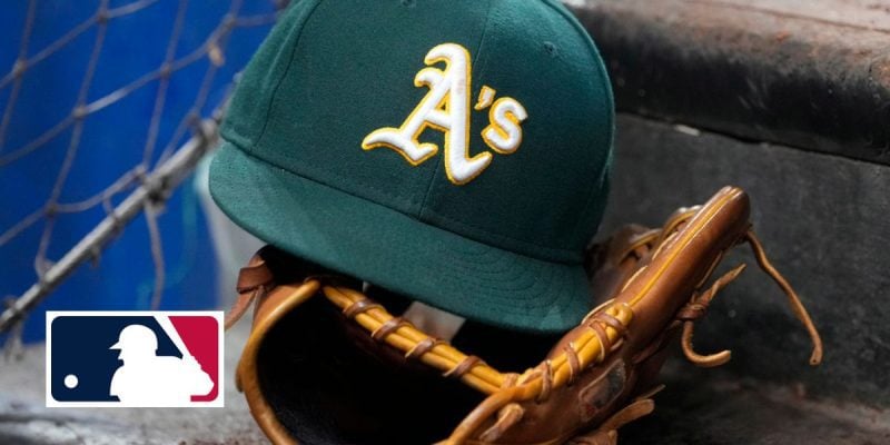 Oakland Athletics hat and glove sits on the dugout steps with MLB logo
