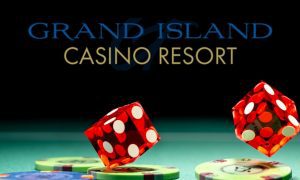 dice falling onto gaming chips on felt table under grand island casino logo