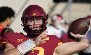 iowa state quarterback hunter dekkers throws a football in uniform