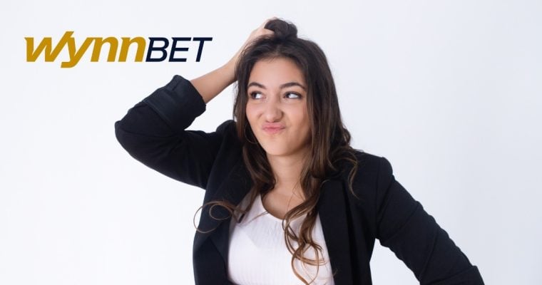 woman scratches head next to the wynnbet logo
