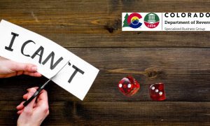 Man's Hands Cut I Can't Into I Can with red dice and Colorado Division of Gaming logo