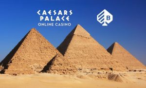 bragg gaming and caesars palace online casino logos above pyramids in sand