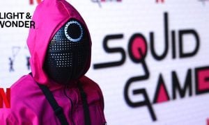 A Character From Netflix Show "Squid Game" with Netflix and Light & Wonder logos