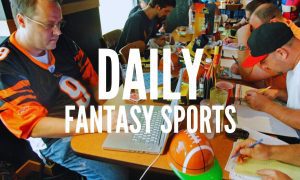 Brian Sherman, Left, Using Laptop For Fantasy Football Draft with daily fantasy sports