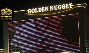 Exterior Of Golden Nugget Casino At Night with Golden Nugget online casino PA app logo