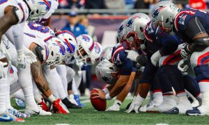 New England Patriots And Buffalo Bills NFL Game line up for the snap at the line of scrimmage