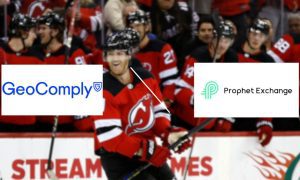 New Jersey Devils Defenseman Dougie Hamilton Smiles after scoring a goal in an NHL hockey game with GeoComply and Prophet Exchange logos