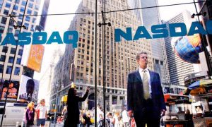 Passer By In Times Square Stops To Look Inside NASDAQ