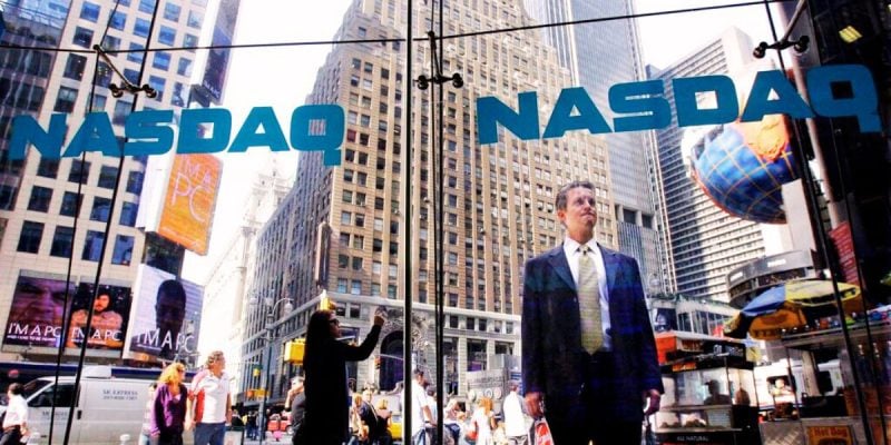 Passer By In Times Square Stops To Look Inside NASDAQ