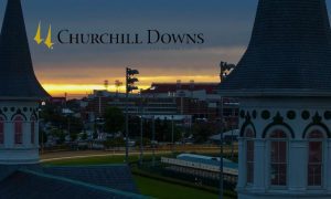 Sun Rises At Churchill Downs Horse Racing Track with company logo