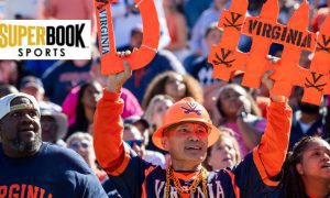Virginia Fans Cheer During NCAA Football Game with SuperBook Sports logo