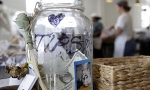 cash in tip jar on desk