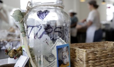 cash in tip jar on desk