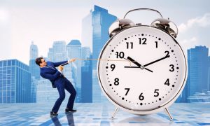 Business Man Holds Back Clock