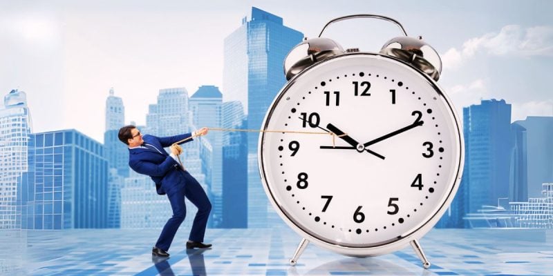 Business Man Holds Back Clock