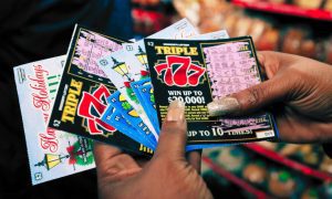 Customer Shows Off Mississippi Lottery Scratchers
