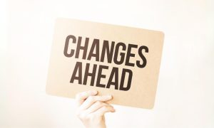 Hand Holds Up Changes Ahead Sign